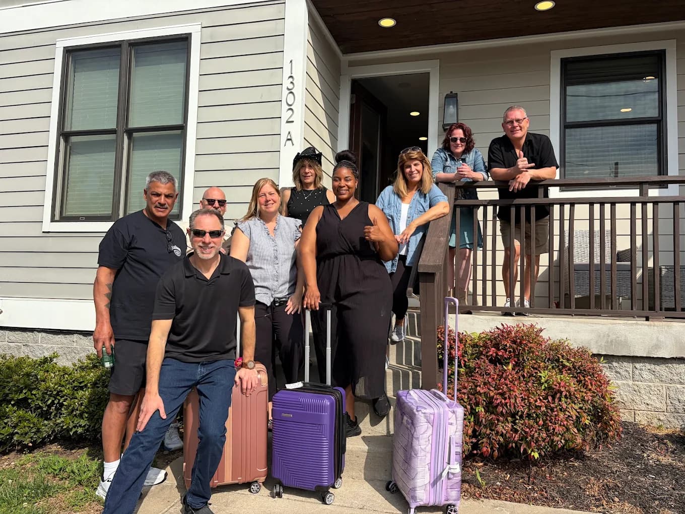 Group of travelers with luggage outside a Nashville rental home